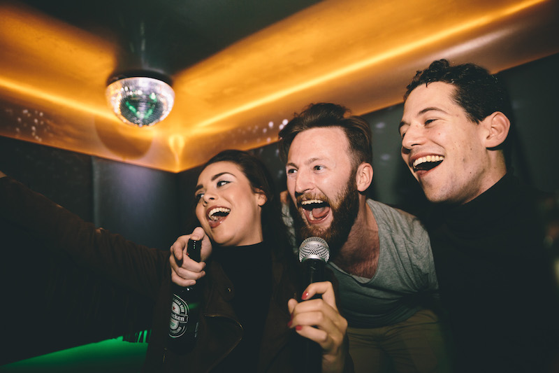 People singing karaoke together